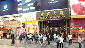 A busy street with a store named 'CHUNGKING MANSIONS'. - Guangdong Guest House (Kowloon)