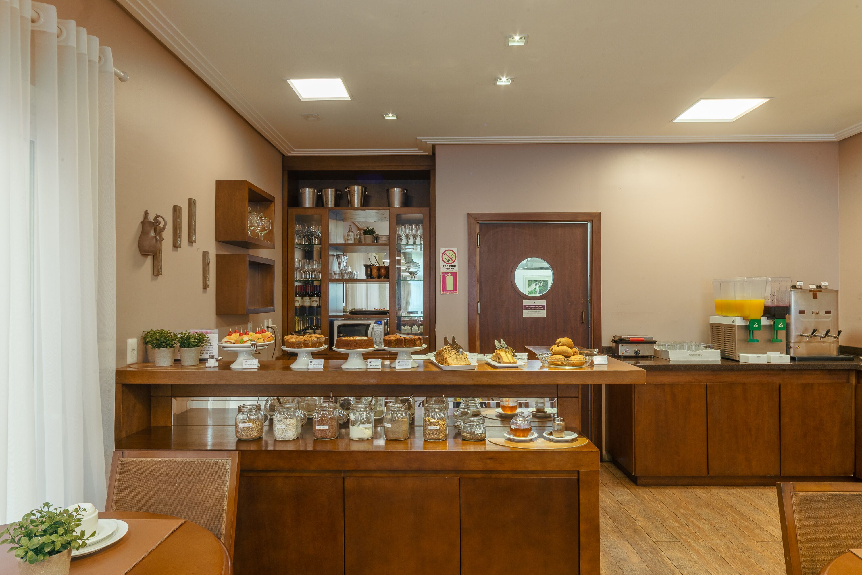 A breakfast bar with various food items and a coffee machine.