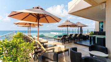 Outdoor pool, open 7 AM to 10 PM, pool umbrellas, sun loungers