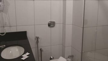 A bathroom with a sink, toilet, and shower.