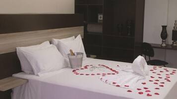 Relax in a beautifully appointed room with a comfortable bed, elegant headboard, and stylish decor.