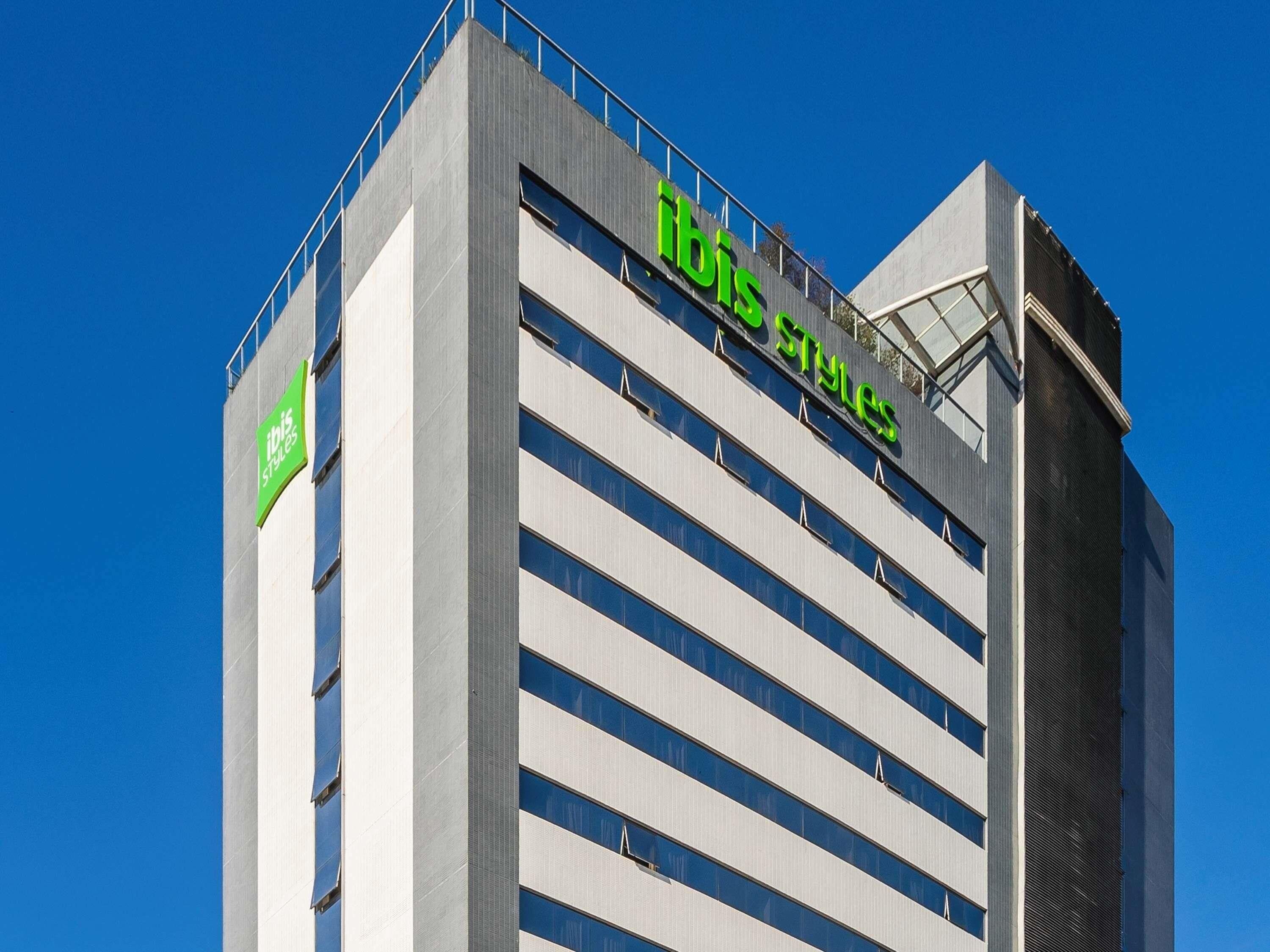 A modern building with a sign reading 'ibis Styles' on the facade.