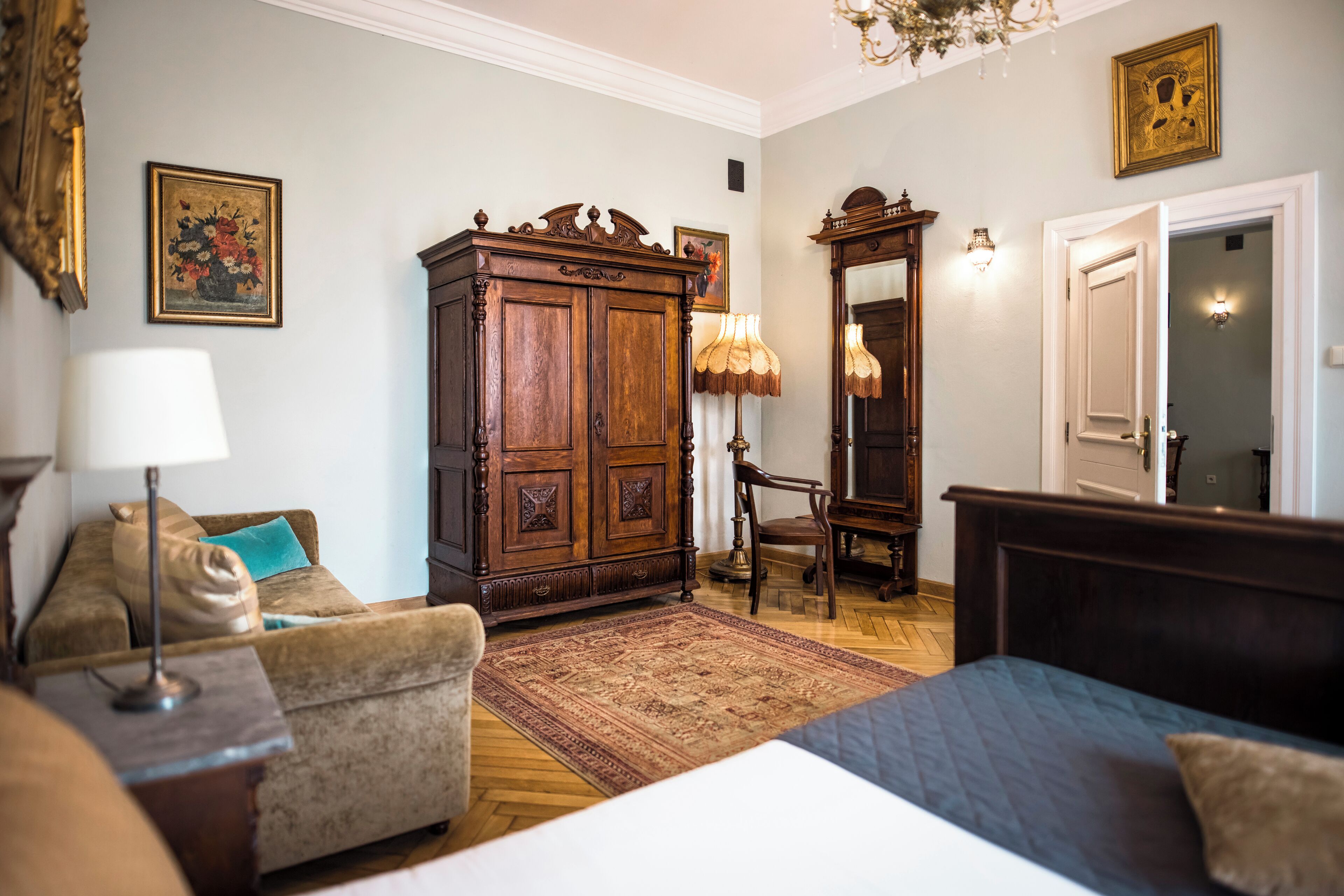 A traditional room with a bed, a wooden cabinet, a chair, and a rug.