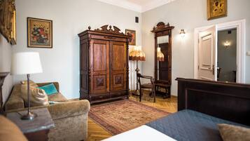 A traditional room with a bed, a wooden cabinet, a chair, and a rug.