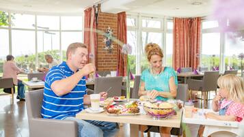 Enjoy meals in a spacious dining area with a large table, multiple seating options, and decorative elements.