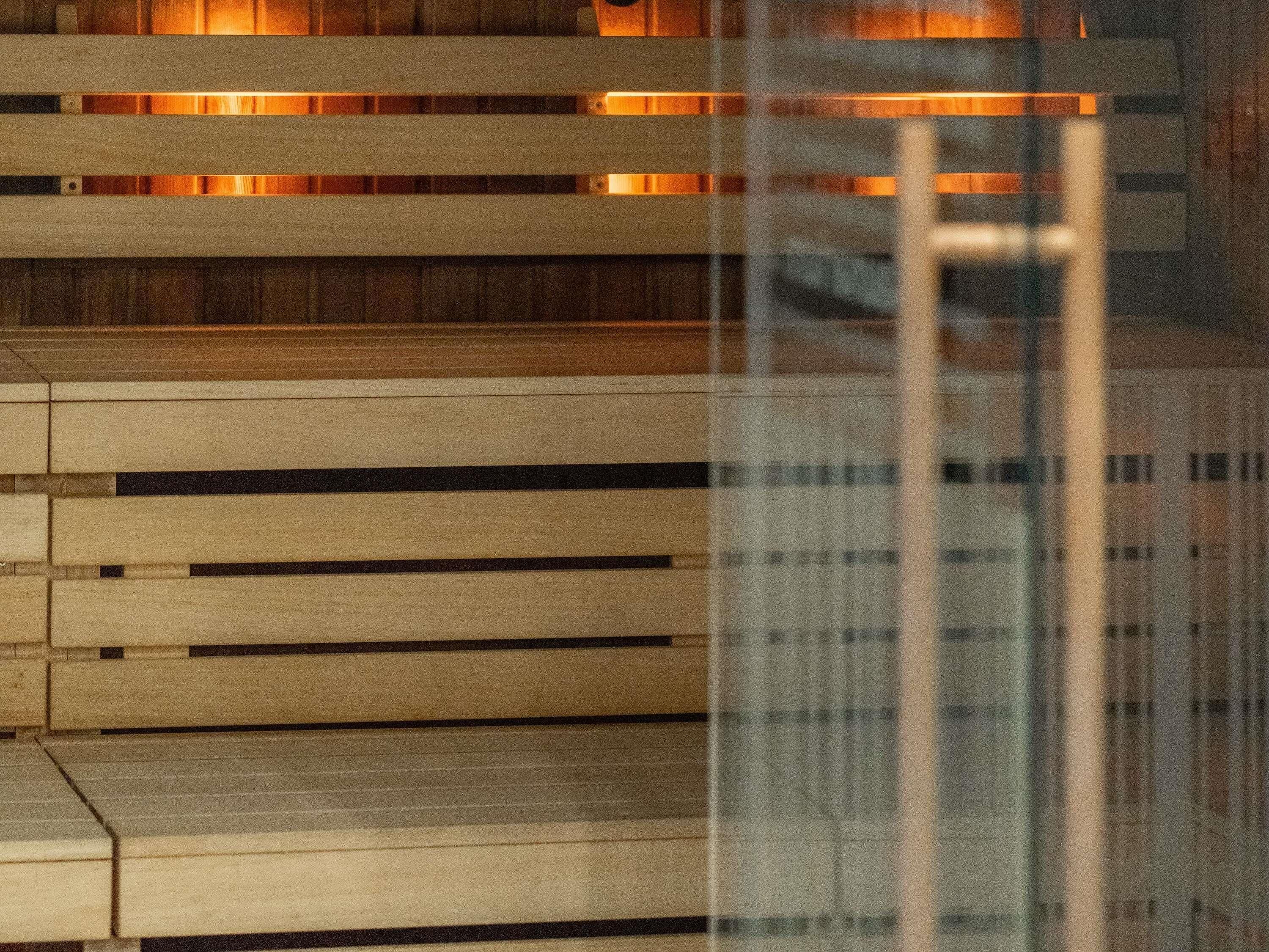 A staircase with wooden steps and a glass railing.
