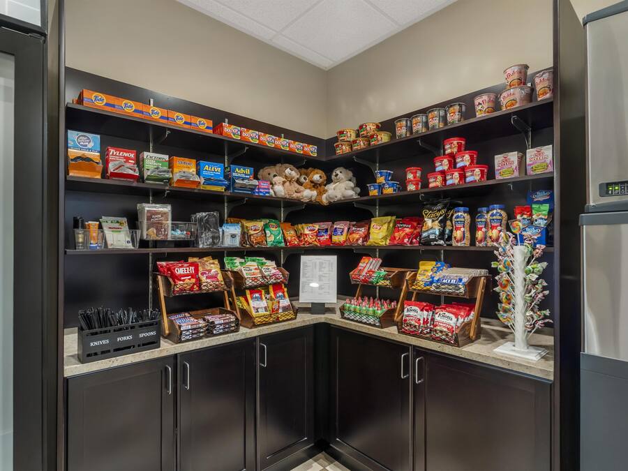 A well-stocked pantry with shelves of food items, including canned goods, snacks, and baking supplies.