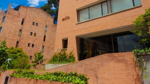 A multi-story brick building with a flat roof and large windows. - Mika Suites (Bogotá)