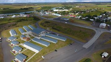 An aerial view of a large industrial complex with multiple buildings, roads, and a river.