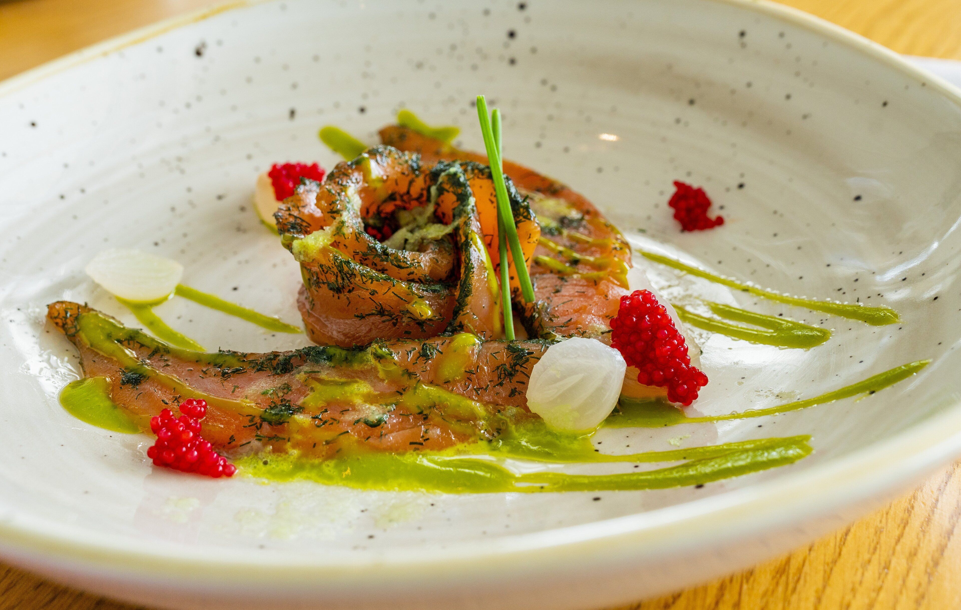 A plate of food with various garnishes and sauces.
