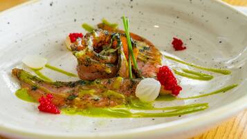 A plate of food with various garnishes and sauces.
