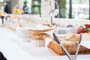A buffet setup with various food items and baskets.