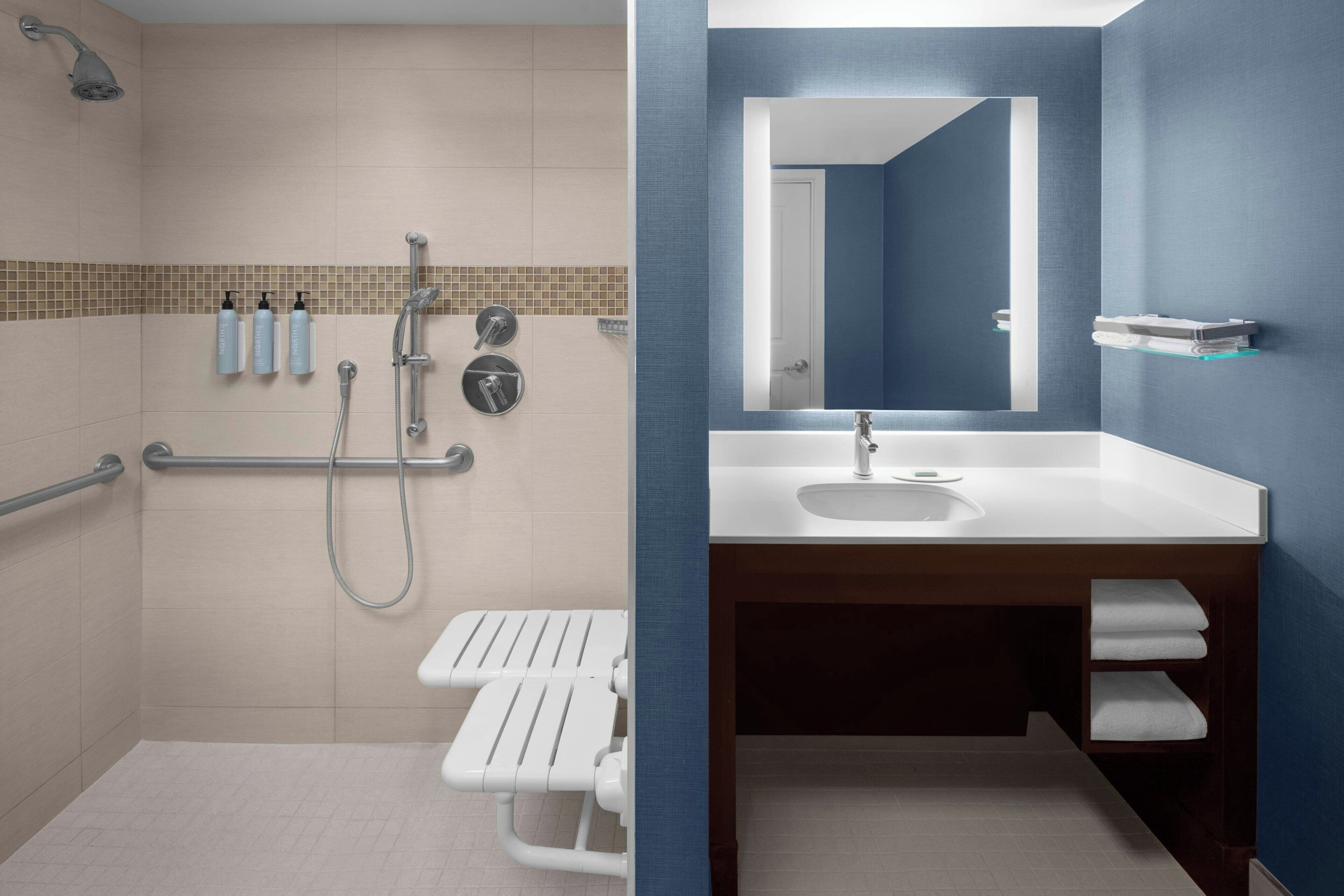 designer toiletries, hair dryer, towels