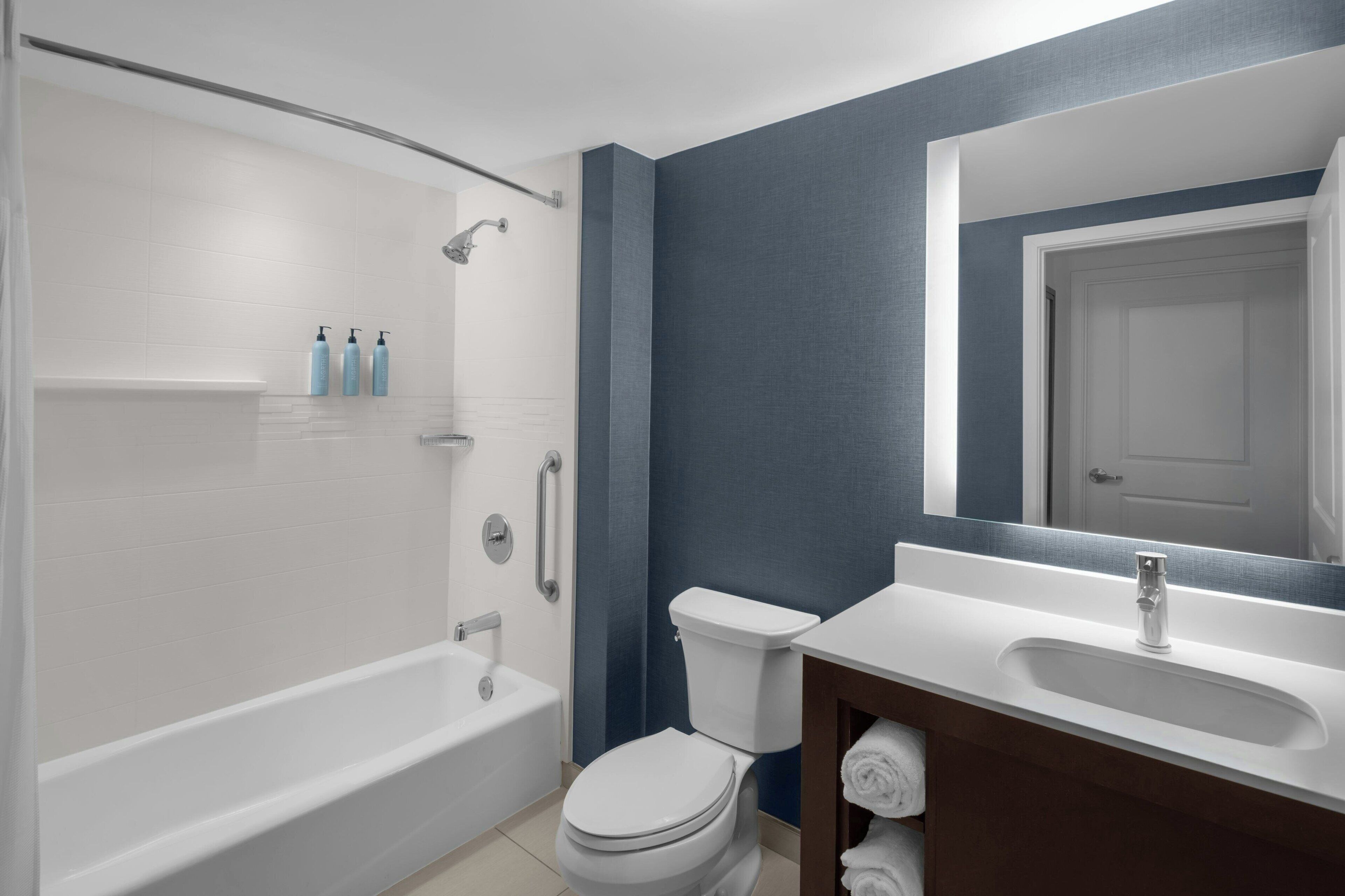 designer toiletries, hair dryer, towels