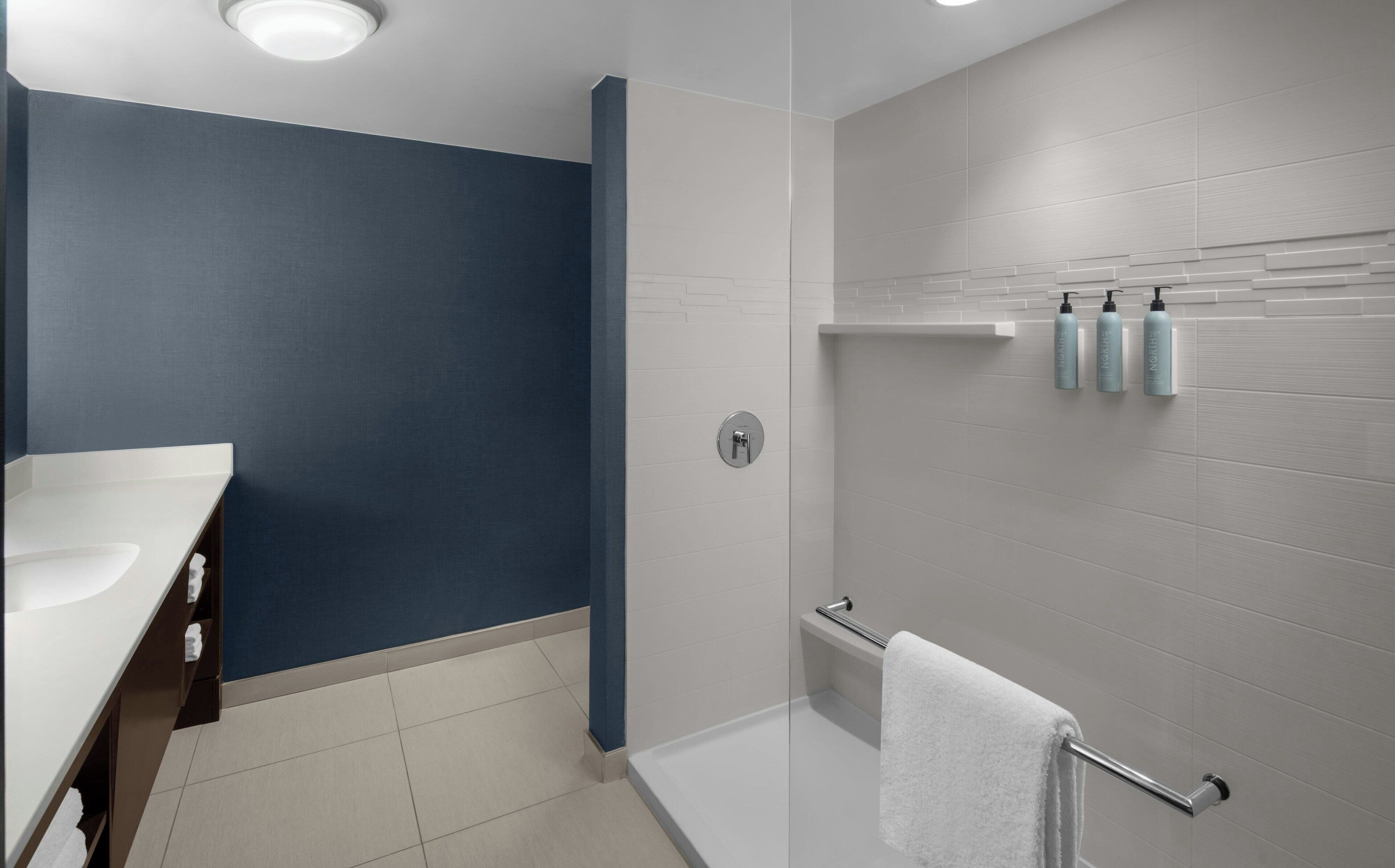 designer toiletries, hair dryer, towels