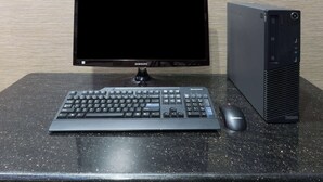 A desktop computer setup with a monitor, keyboard, mouse, and a desktop tower on a granite table. - Super 8 by Wyndham San Antonio Near Fort Sam Houston (San Antonio)