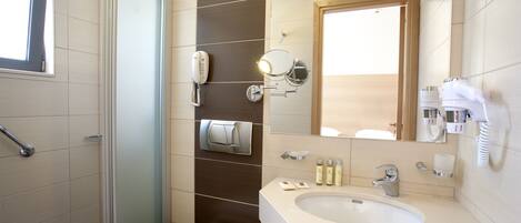 A modern bathroom with a shower, toilet, and sink.