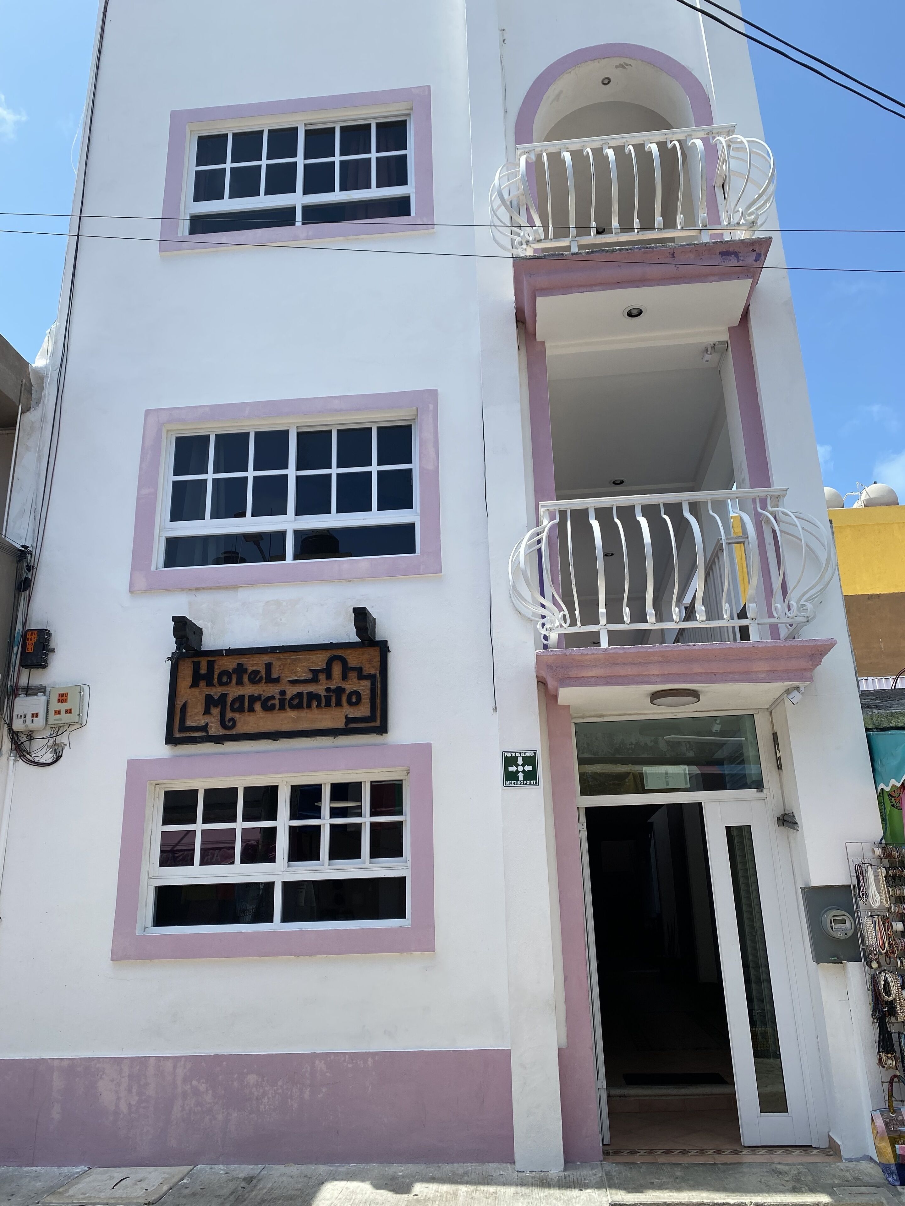 A multi-story building with a sign reading "Hotel Marciatito".