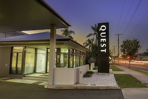 Experience the sleek, contemporary design of QUEST, featuring a flat roof and large glass windows.