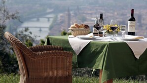 A table set outdoors with a view of a bridge and river. - Corte San Mattia - Agriturismo in Verona (Verona)