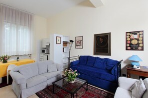 Relax in this stylish living space, featuring a sofa, coffee table, and dining area.