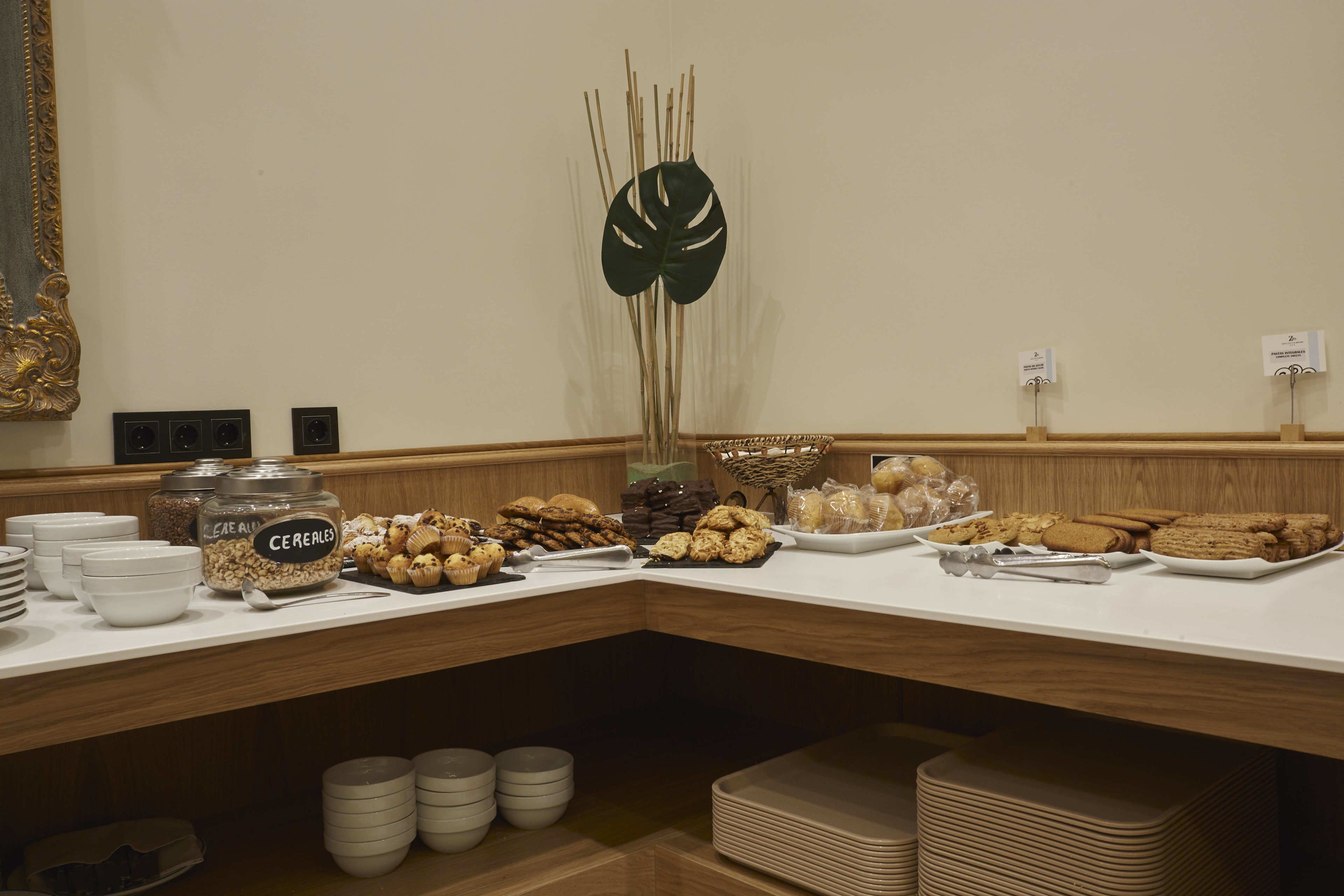 A buffet setup with various food items and serving dishes.