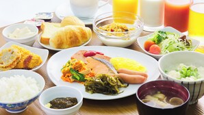 A breakfast table with various dishes, drinks, and condiments. - Hotel Peace Island Naha (Naha)