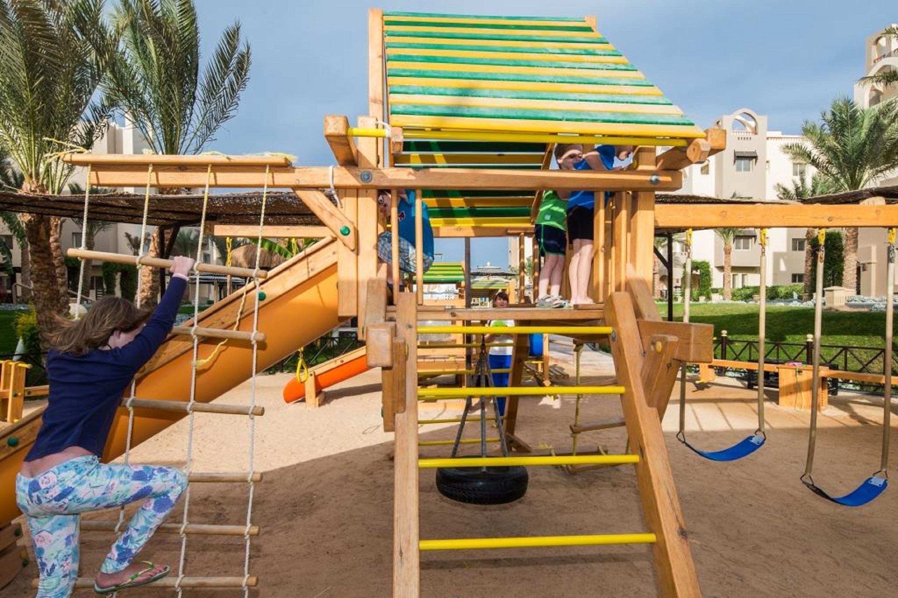 A playground with climbing structures and swings.