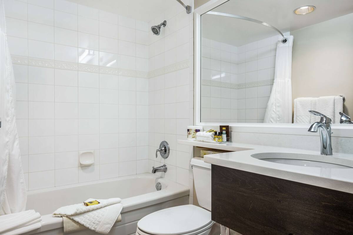 standard room, 2 queen beds, non smoking, refrigerator & microwave | bathroom | combined shower/bathtub, designer toiletries, hair dryer, towels