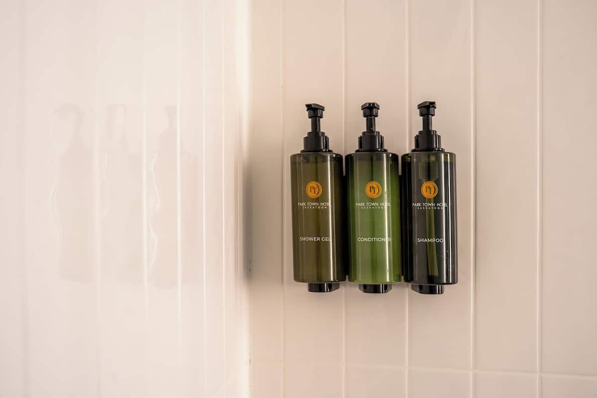 bathtub, designer toiletries, hair dryer, towels