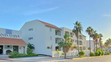 A hotel named 'SANTA MARIA HOTEL & SUITES' with a white facade, red-tiled roof, and multiple balconies.