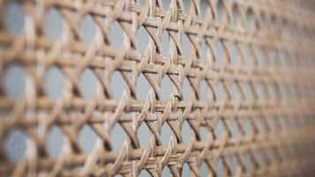 A close-up of a woven, circular-patterned material, likely a part of a fence or barrier.