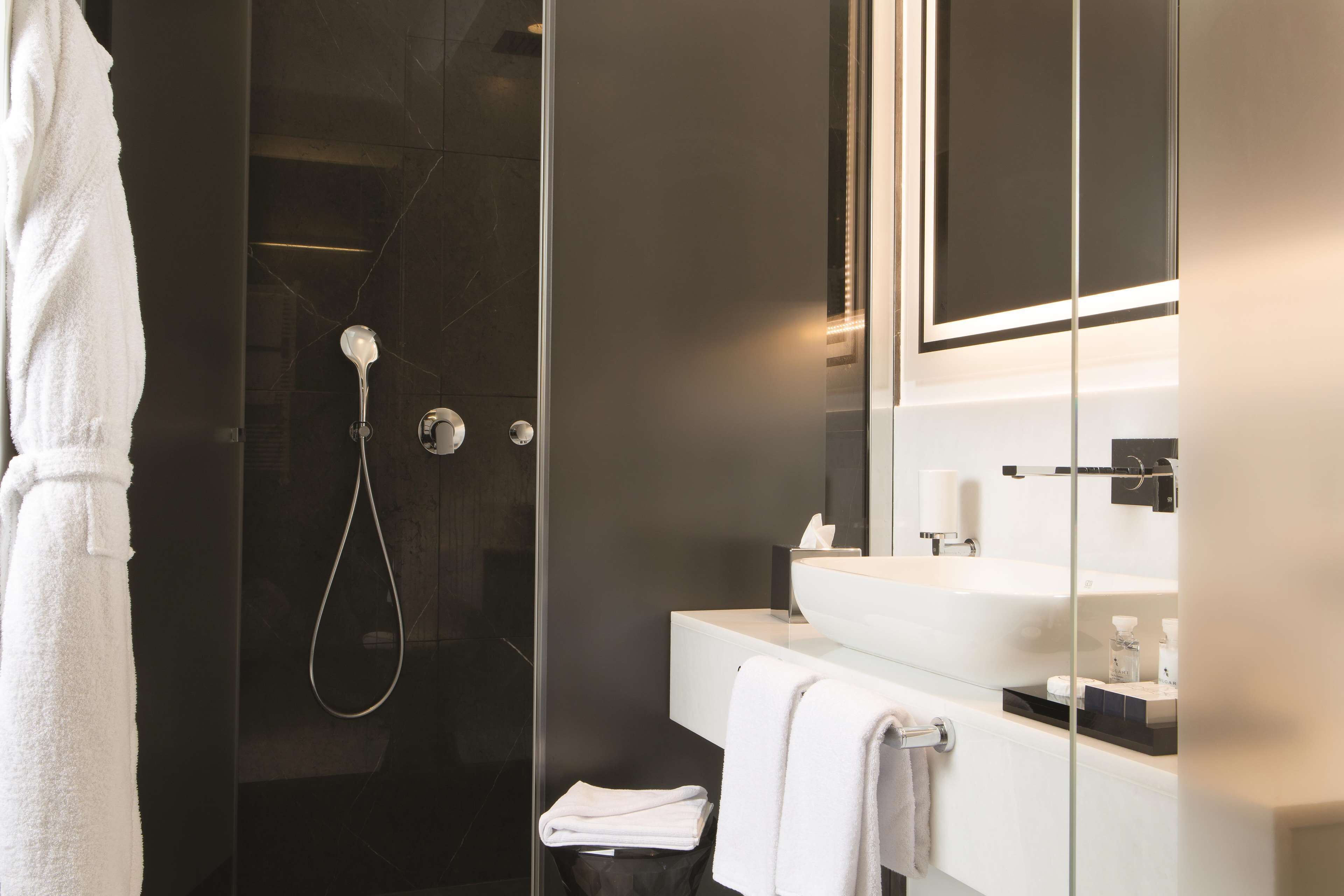 panoramic suite, balcony, city view | bathroom | shower, rainfall showerhead, designer toiletries, hair dryer