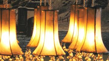 A row of hanging lamps with a warm glow, suspended from chains.