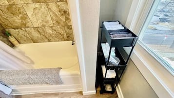 Combined shower/bathtub, hair dryer, towels, soap