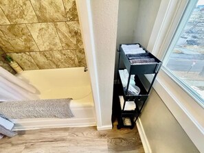 Combined shower/bathtub, hair dryer, towels, soap - Stay on Spring | A Classy Stay Downtown | #6 (Sioux Falls)