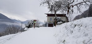 Situated on a snow-covered slope, this mountain lodge offers a serene retreat.
