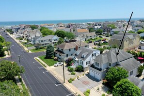 A residential area with houses, a street, and a view of the ocean.