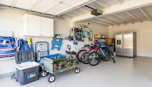A garage with bicycles, a refrigerator, and storage containers. - 2 short blocks to the beach. FULLY RENOVATED HOUSE WITH NEW HOT TUB. (Point Pleasant Beach)