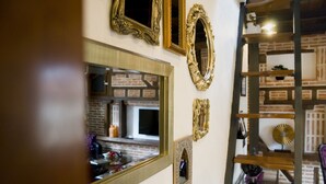 A wall with various ornate mirrors and picture frames.