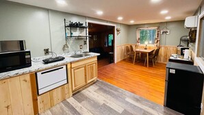 A compact kitchen with wooden cabinets, a built-in microwave, and a sink. - Romantic Cabin, Mnt View, Perfect Location❤️ (Gatlinburg)