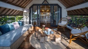 A cozy, open-plan living area with a high ceiling, comfortable seating, and a view of the interior space. - Luxury Complex 16 BR in the heart of Seminyak (Seminyak)