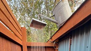 A wooden outdoor shower area with a metal bucket and a door. - Discover Funky Bunky: Your Rustic Retreat 5 Min from Nelson (Nelson)