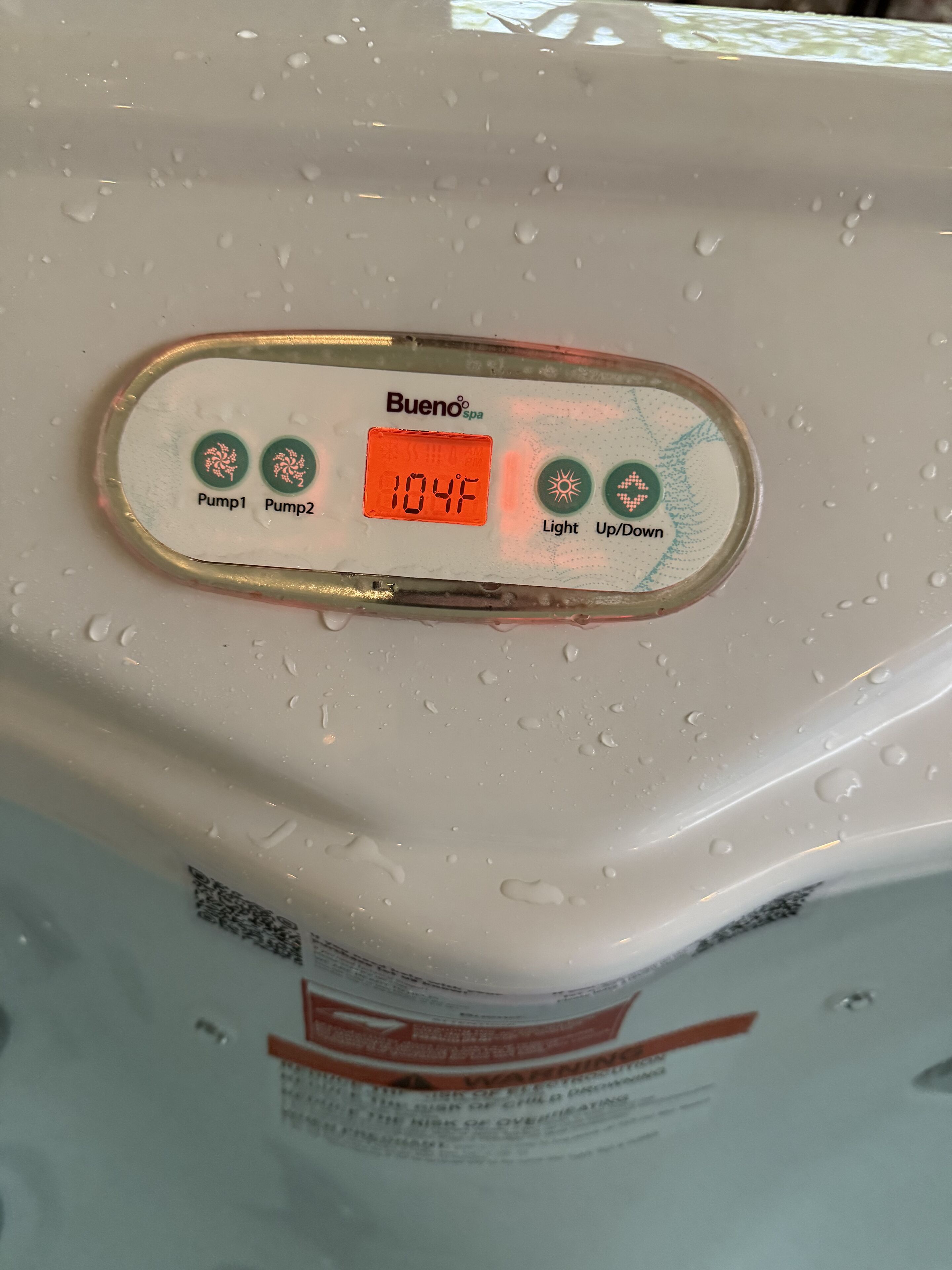 A control panel with two buttons labeled 'Pump1' and 'Pump2', an orange digital display reading '104F', and two status indicators labeled 'Light' and 'Up/Down'.