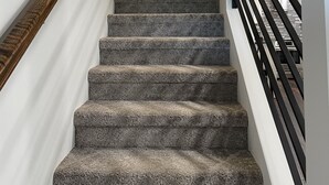 A carpeted staircase with a black handrail, leading to a door at the top. - Home Near Main Street-Covered Patio-Hot Tub! (Saint Charles)