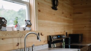 A kitchen with wooden cabinets, a double sink, and a stove. - Little House on Dairy- Near Ark- Feed Grain to Calves and Goats (Dry Ridge)