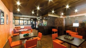 A restaurant with wooden ceiling, orange chairs, and tables. - WONDERFUL APARTMENT IN RESIDENCE WITH A VIEW. (Sestriere)