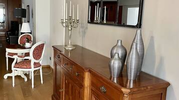 A wooden dining area with a table, chairs, and a candelabra.