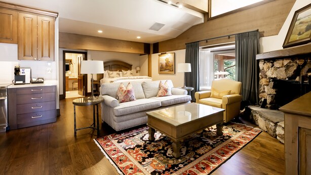A spacious living area with a sofa, armchairs, a coffee table, and a fireplace. - Sterling One Bedroom Suite in Great location with Majestic Mountain Views 1 Condo by RedAwning (Park City)