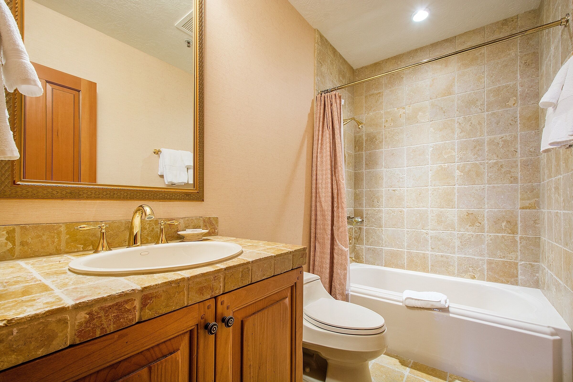 A bathroom with a sink, toilet, and bathtub.